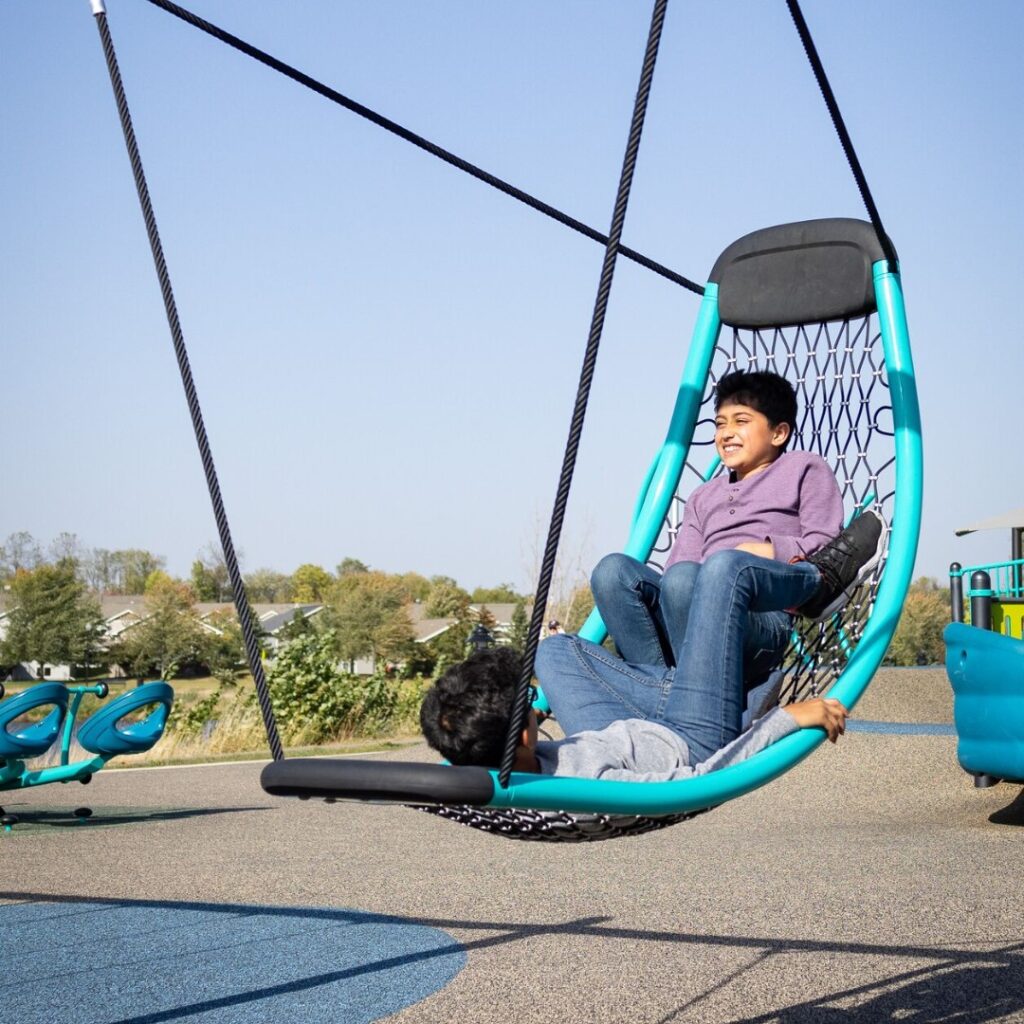 2 smiling boys on a Flexx™ Swing