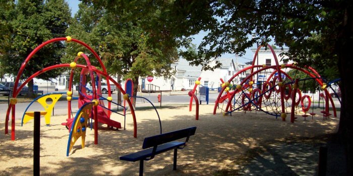 Photo of 2 play arching structures with attached climbers and slides