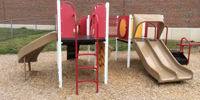 Photo of a play structure for 2-5 year olds with climbers and slides