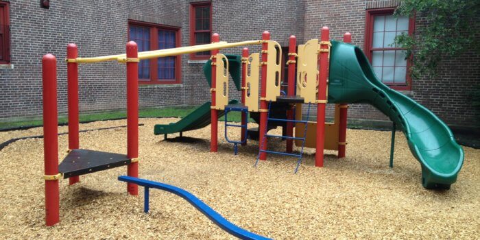 Photo of playground with slides, climbers, and balance beam
