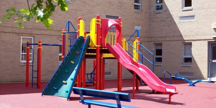 Photo of a play structure with climbers and a slide