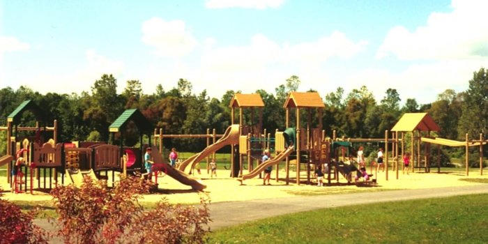 Photo of playground with slides, climbers, and multiple levels of decks.