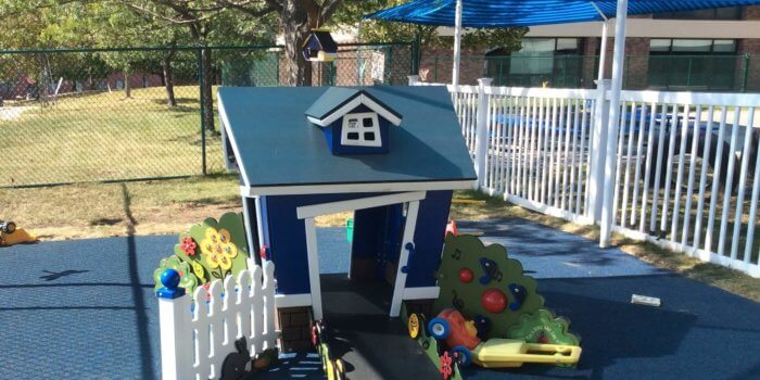 Photo of a shaded house-shaped play structure for young children
