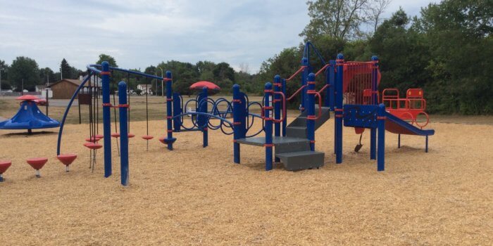 Photo of playground with slides, climbers, and step bridges.