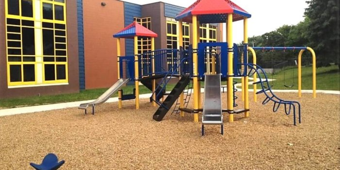Photo of playground with slides and climbers.