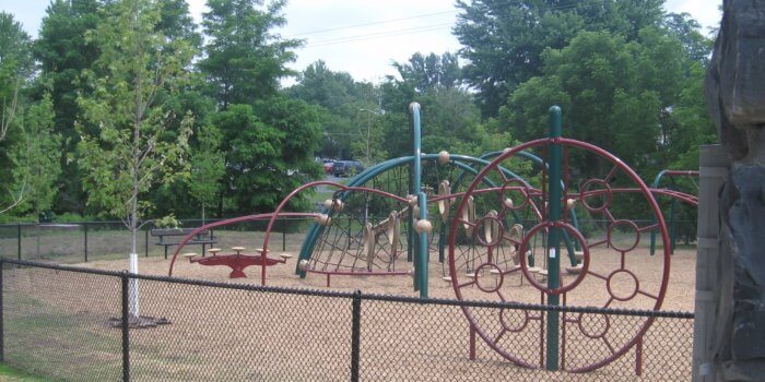 Photo of curved play equipment with climbers and bridges.