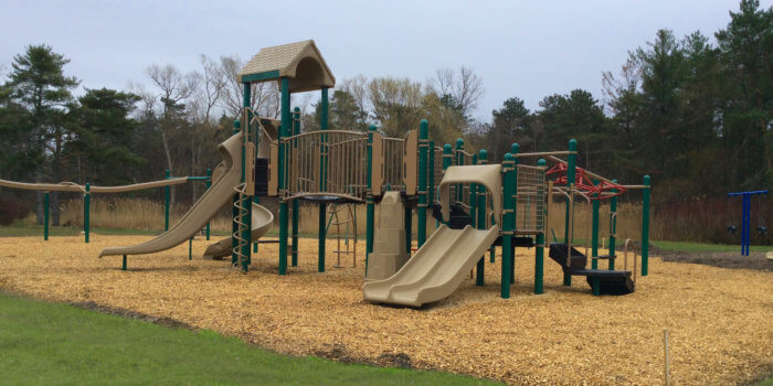 Photo of playground with several slides, climbers, bridges, and decks.