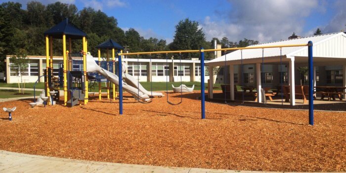 Photo of playground with slides, climbers, and independent components.