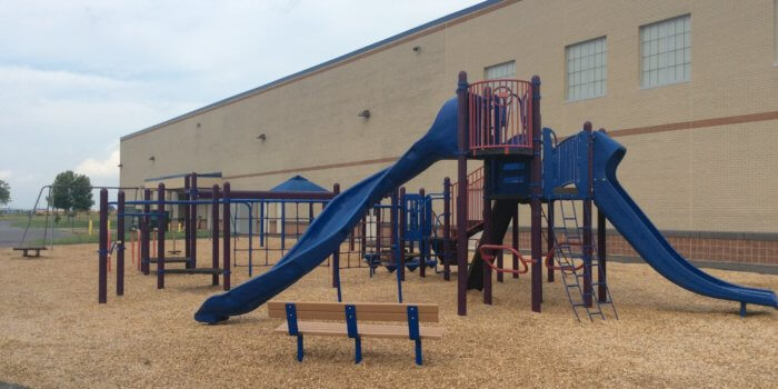 Photo of playground with slides, bridges, and climbers.