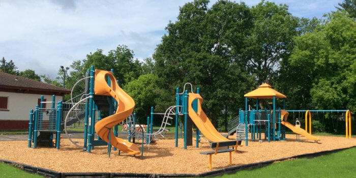 Photo of playground with slides, climbers, and swings.