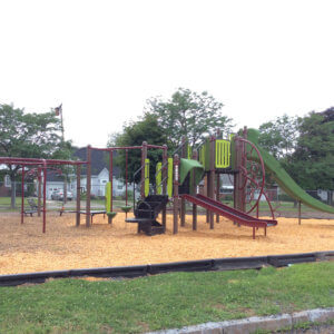 Photo of playground with slides, climbers, and overhead play components.