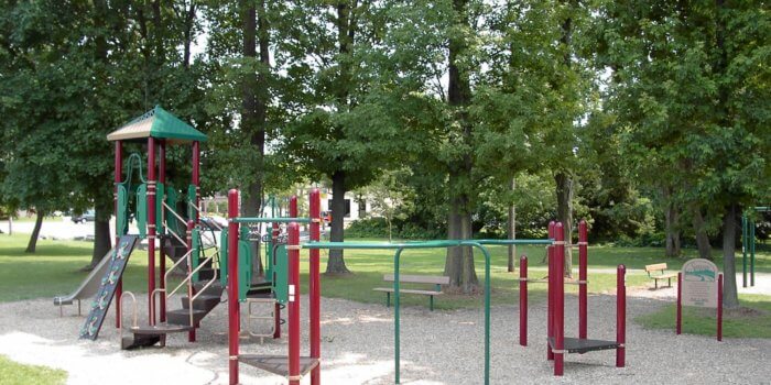 Photo of playground with climbers, slide, and overhead play components.